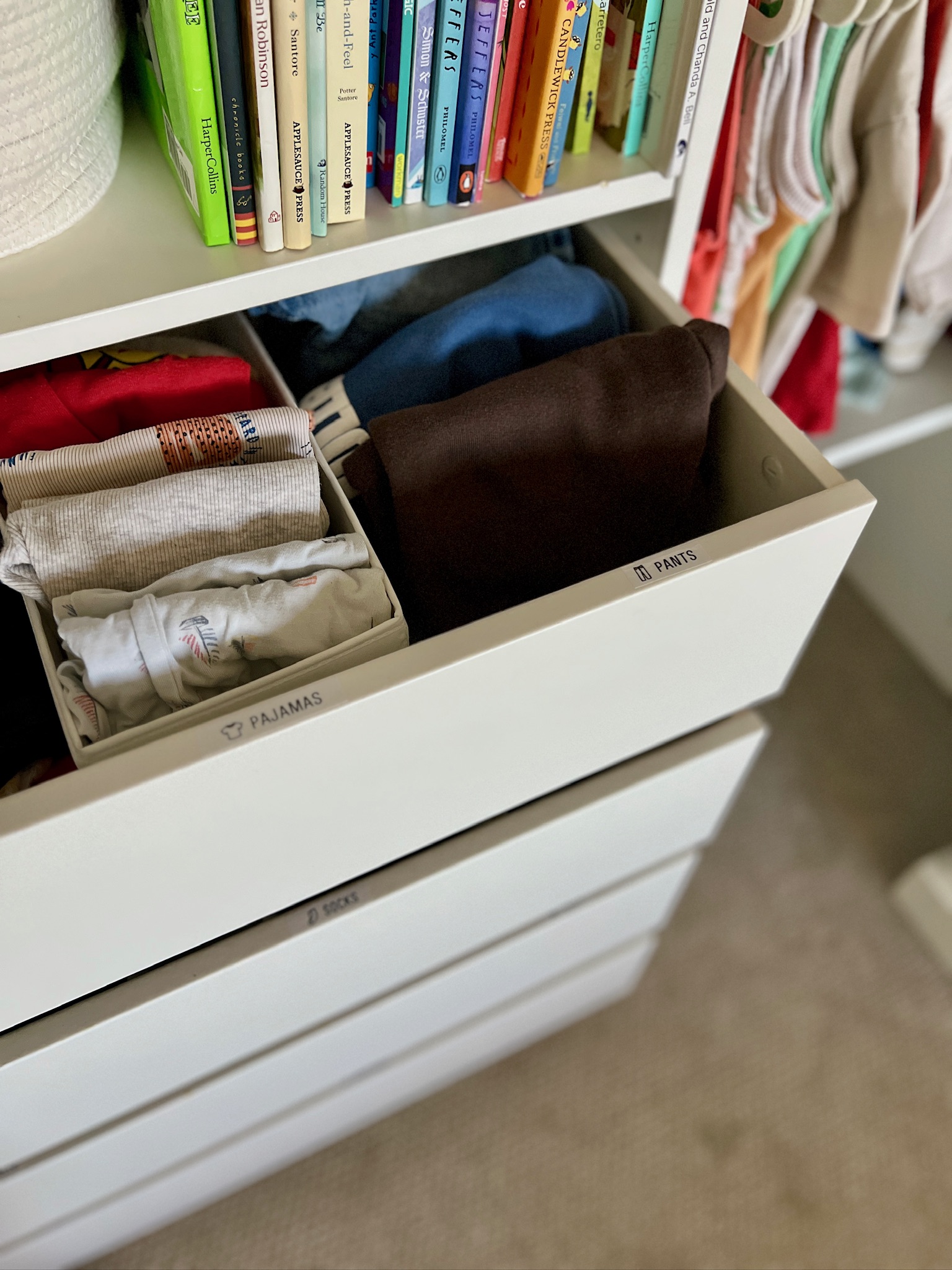 Detailed view of organized drawers labeled pajamas, pants, shorts, and socks.